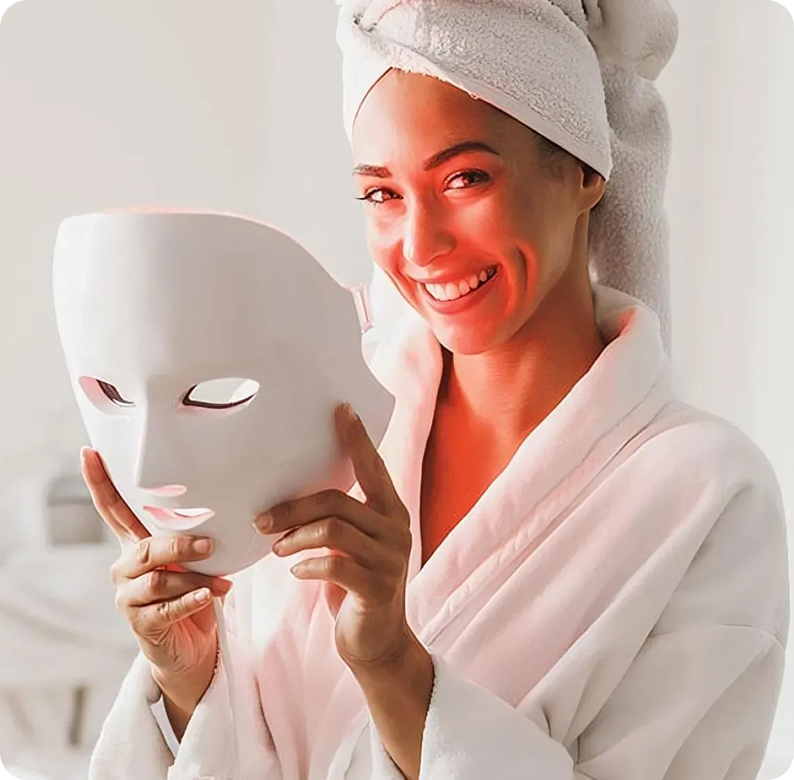 Woman using the Glokore LED Therapy Mask and looking happy